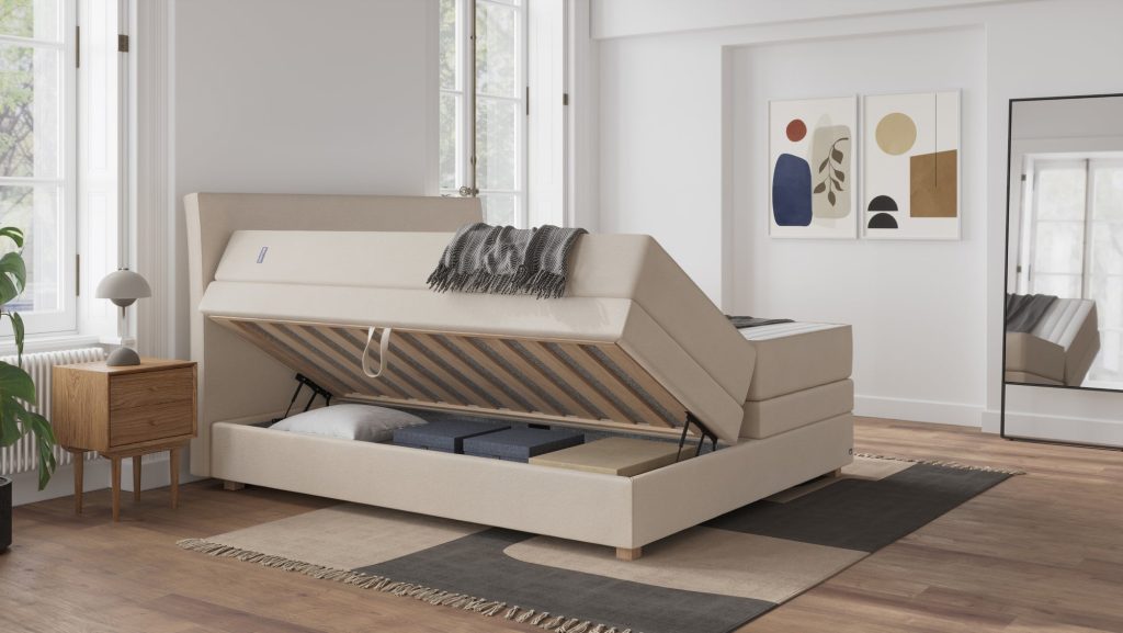 Bruno Boxspringbett Premium mit Stauraum in Beige mit aufgeklapptem Bettkasten und verstauter Bettwäsche