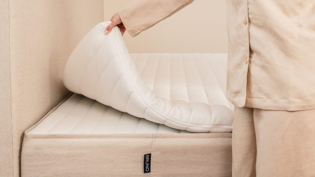 Bruno Topper Premium wird auf die Matratze eines Boxspringbetts gelegt